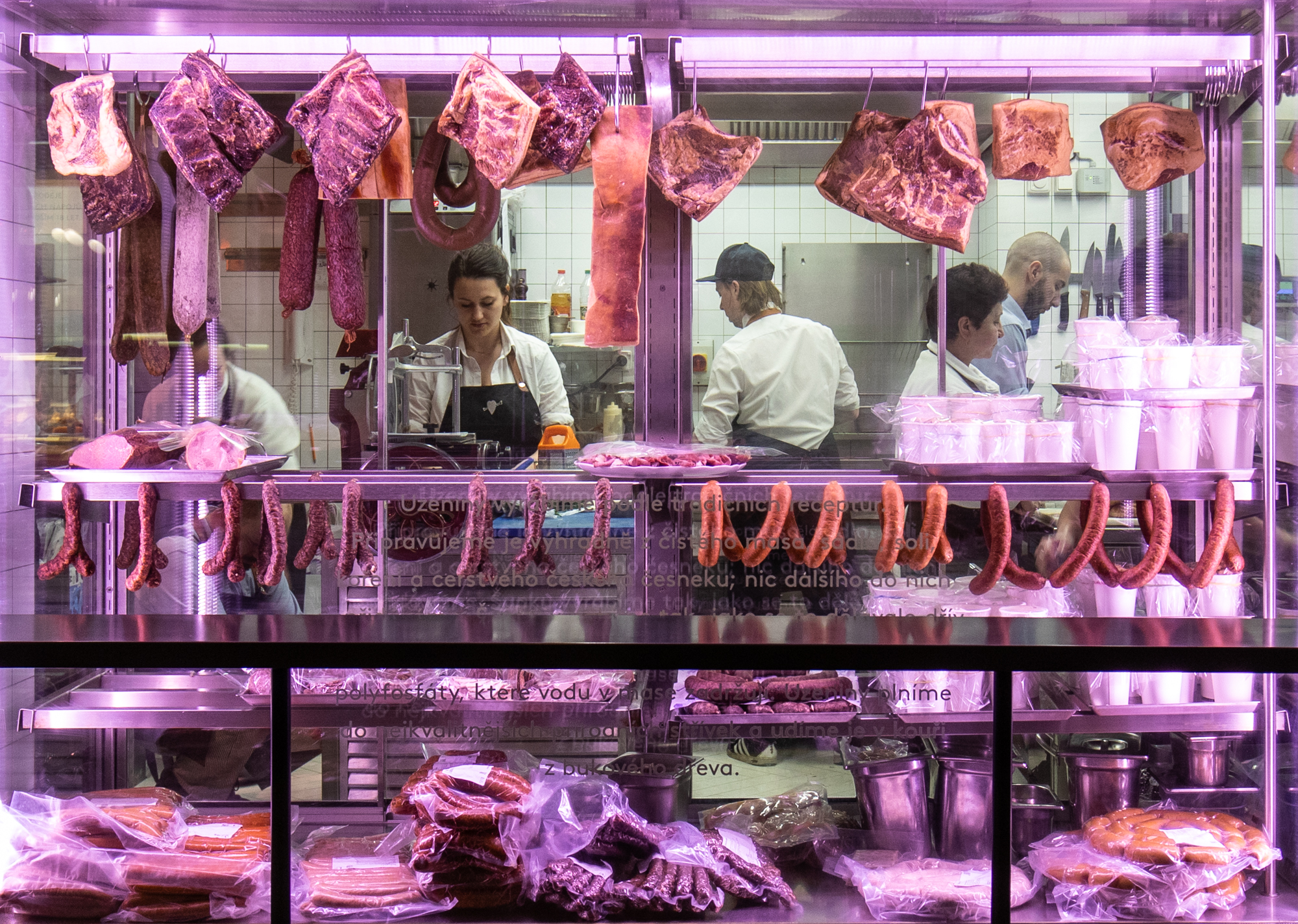 The window display and butchers at work at Naše maso in Prague